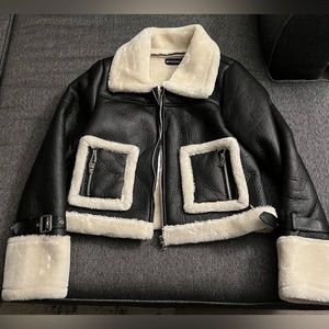 New faux leather jacket with faux fur lined inside. Very cozy, and soft.